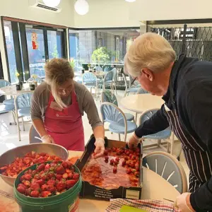 Emily-Drescher-and-Bruce-Hall-preparing-food-at-St-Marys-House-of-Welcome-3-1